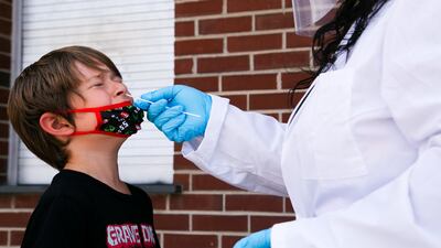 Nurse Alisa Ellis-Balogun tests 7-year-old Thomas Byrd for coronavirus at Seneca High School a day before returning to school in Louisville, Kentucky, US, on August 10, 2021. Reuters