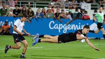 A Dubai English Speaking College player dives over for a try.