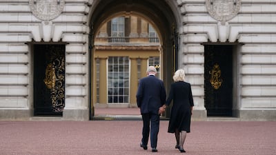 King Charles and Queen Camilla walk across the forecourt of Buckingham Palace, London, as he enters the palace for the first time as the new King in September 2022