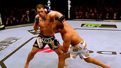 Junior Dos Santos lands a punch on Cain Velasquez in their first, short, encounter.