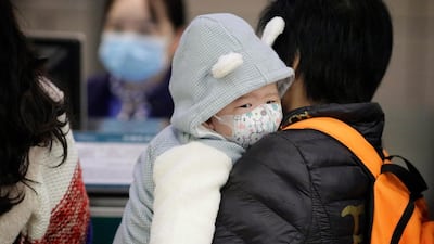 A child wears a mask at Guangzhou airport in Guangzhou. EPA