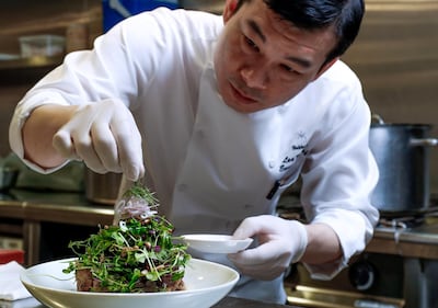 Hakkasan Executive Chef, Lee Kok Hua, demonstrates how to make Crispy Duck Salad. Victor Besa / The National