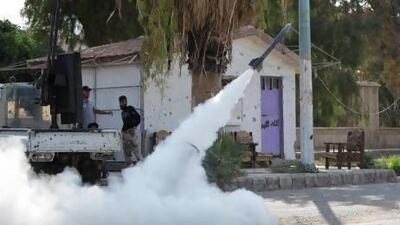 Members of the Free Syrian Army fire a homemade rocket towards forces loyal to Syria's president Bashar Al Assad in Deir Al Zor.