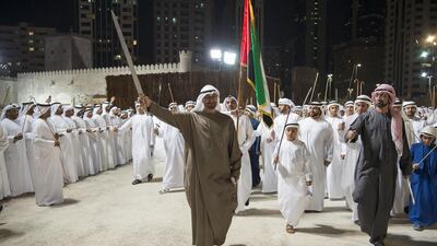 Sheikh Mohammed bin Zayed, Crown Prince of Abu Dhabi and Deputy Supreme Commander of the Armed Forces, dances with Sheikh Ammar bin Humaid Al Nuaimi, Crown Prince of Ajman, and Sheikh Zayed bin Mohammed bin Hamad, centre, dance on the opening day of the Qasr Al Hosn Festival. Rashed Al Mansoori / Crown Prince Court - Abu Dhabi