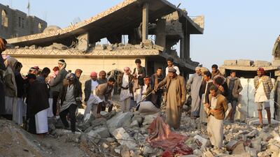 Yemenis gather at the remains of a house hit by a US strike in Saada on Sunday. At least two dozen people lost their lives in American bombardments at the weekend. Reuters