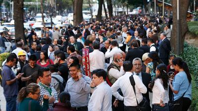 People stand along Reforma Avenue after a 7.2-magnitude earthquake shook Mexico City. Marco Ugarte / AP Photo