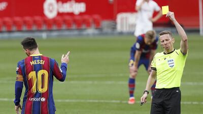 Barcelona's Lionel Messi is shown a yellow card by referee Alejandro Hernandez Hernandez. EPA