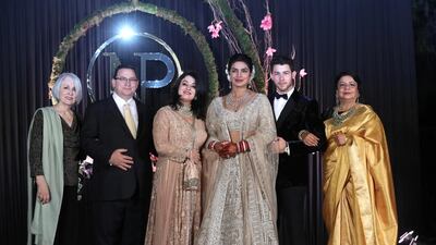 Priyanka Chopra (3-R) and US musician Nick Jonas (2-R) pose for photographs with family members, the bride's mother Madhu Chopra (R), the groom's father Paul Kevin Jonas Sr. (2-L), mother Denise Miller Jonas (3-L) and grandmother Frances Madonia-Miller (L) during a reception in New Delhi, India, 04 December 2018.