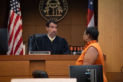 Fulton County Superior Court Judge Robert McBurney receives documents from County Court Clerk Che Alexander on August 14, 2023 in Atlanta, Georgia. AFP