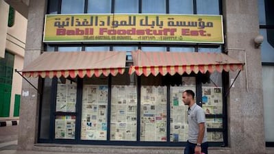 A man walks by the Babil Foodstuff Est., a recently closed convenience store in the city block between Airport and Muroor, and Delma and Mohamed Bin Khalifa streets in Abu Dhabi. Silvia Razgova/The National
