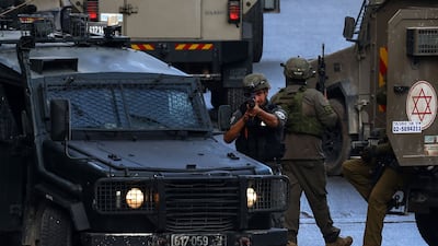 Israeli army vehicles block a road during a raid in Nablus, in the occupied West Bank. AFP