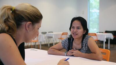 Potential sponsor Katherine Janssen, left, interviews housemaid Desiree Condino during one of the regular speed-recruiting events at the Dome@Rawdhat facility in Abu Dhabi. Satish Kumar / The National