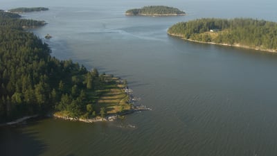 Saturnina Island (at the rear), in the Salish Sea, off the eastern coast of Vancouver, has been purchased by Chip Wilson, founder of lululemon athletica, who wants to preserve it for future generations. Wikimedia Commmons / Ken Walker