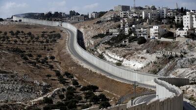The Palestinian city of Abu Dis is seen near the Israeli separation barrier in the West Bank. Ahmad Gharabli / AFP Photo