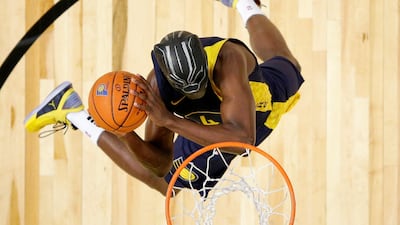 Indiana Pacers' Victor Oladipo dunks while wearing a mask from the movie "Black Panther" during the NBA basketball All-Star weekend slam dunk contest in Los Angeles. Bob Donnan / via AP