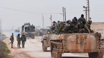 Syrian government forces enter the village of Tel-Toukan, in Idlib province, north-west Syria. AP