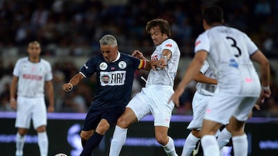Italian forward Roberto Baggio, left, vies with Argentinian midfielder Ricardo Alvarez during the “Match for Peace” game at Rome’s Olympic Stadium on September 1, 2014. Filippo Monteforte / AFP