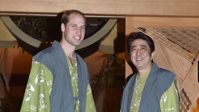 Britain’s Prince William (L) and Shinzo Abe wearing "yukatas", or kimono-style cotton outfits as they pose together before a dinner in Koriyama in Fukushima prefecture on February 28, 2015. AFP