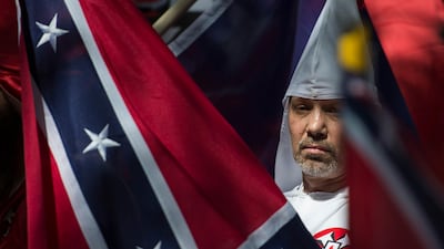 A member of the Ku Klux Klan during a rally, calling for the protection of Southern Confederate monuments, in Charlottesville, Virginia. Thousands of white nationalists, including supporters of the Ku Klux Klan white supremacist group, and anti-fascist activists are clashing in the city. Andrew Caballero-Reynolds / AFP.