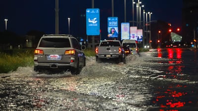 Cars make their way through the water in Khalifa City in the capital. Victor Besa / The National