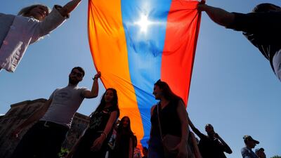 Supporters of opposition lawmaker Nikol Pashinian carry a large Armenian flag as they protest in Republic Square in Yerevan. Sergei Grits / AP Photo