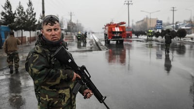 An Afghan security officer stands guard as he secure the site of a suicide attack which targeted the entrance gate of Marshal Fahim Military Academy in Kabul, Afghanistan. EPA