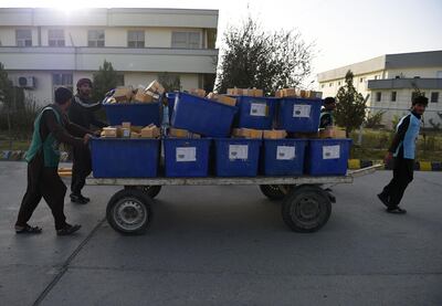 Afghan election workers pull a cart loaded with biometric devices to be used in the parliamentary election on October 20, 2018. AFP