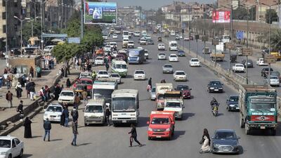 Vehicles driving along a street in Cairo. Getty Images
