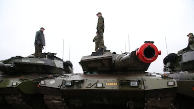Swedish soldiers stand on top of parked Stridsvagn 122 tanks during training outside Visby on the Baltic island of Gotland, Sweden. Reuters