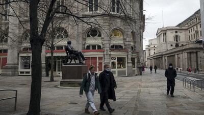 Pedestrians walk near the Bank of England in central London. Getty Images