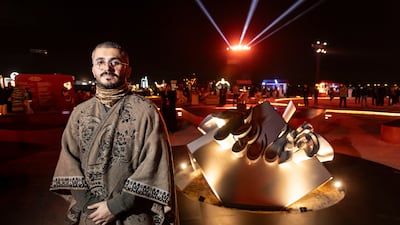 Artist Ghaleb Hawila with his artwork The Cube
