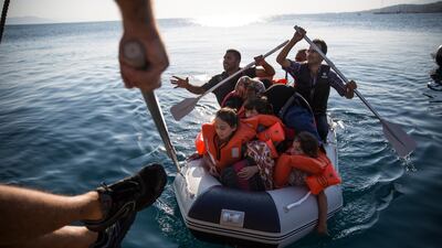A Syrian family arrives in an inflatable dinghy at Kos ferry port after crossing from Turkey on August 30, 2015. Dan Kitwood / Getty Images