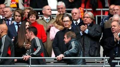 Liverpool owner John W Henry, centre top, fired Kenny Dalglish, centre bottom, after the club's poor league results. Nick Potts / PA