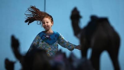 GEMS World Academy student Lara Elbilly, 6, runs through the school courtyard during one of its National Day events for students.