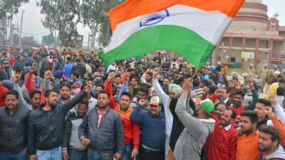 An man waves the Indian national flag at Wagah. AP Photo