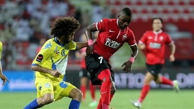 Ismail Al Hamadi of Al Ahli, right, and Abdalla Al Naqbi of Al Dhafra in action during their Arabian Gulf League contest on Sunday. Satish Kumar / The National