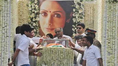Sridevi's husband Boney Kapoor, centre, stands beside the body of his wife. Rafiq Maqbool / AP Photo