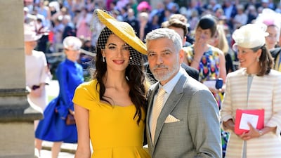 Amal, in canary Stella McCartney, and George Clooney arrive at St George's Chapel at Windsor Castle before the wedding of Prince Harry to Meghan Markle on May 19, 2018. Getty Images