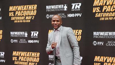 Floyd Mayweather poses for the media as he arrives for Wednesday's press conference to hype the Mayweather v Pacquiao May 2 fight. Stephen Dunn / Getty Images / AFP