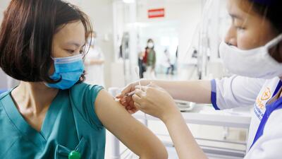 A medical worker receives a shot of Covid-19 vaccine at Thanh Nhan hospital in Hanoi, Vietnam. EPA