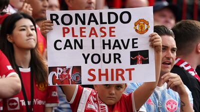 Fans brandish a Cristiano Ronaldo sign during the game at Old Trafford. PA