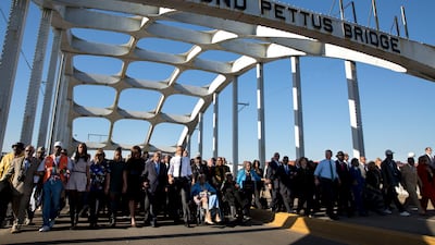 Mr Obama, wife Michelle, her mother, daughters Malia and Sasha join John Lewis, George W Bush, his wife Laura and other dignitaries to march across the Edmund Pettus Bridge to commemorate the 50th Anniversary of Bloody Sunday, March 7, 2015. Photo courtesy of the National Archives
