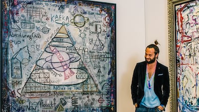 British-Indian artist Sacha Jafri next to two of his works at his home studio on Palm Jumeirah in Dubai. Alex Atack for The National
