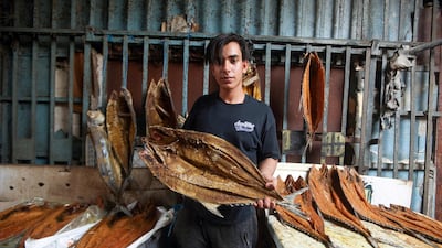 A man poses with Basra dried fish masmouta, at a market in the Iraqi city. Reuters