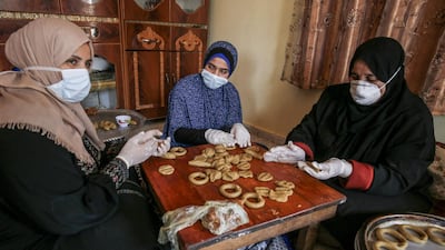 Palestinian women make traditional biscuits in preparation for the upcoming Eid Al Fitr holiday in Rafah, Gaza Strip. AFP