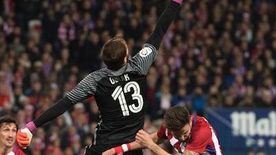 Atletico Madrid’s Slovenian goalkeeper Jan Oblak, left, clears the ball. Curto de la Torre / AFP