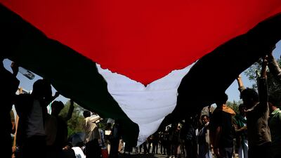 Protesters hold a Palestinian flag, at Sana'a University, Yemen. EPA