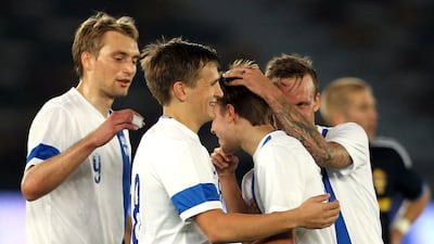 Finland's Riku Riski is congratulated by team-mates after scoring the winning goal against Sweden at Zayed Sports City on January 19, 2015. AFP/STR