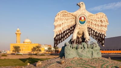 The UAE emblem is the inspiration for a falcon monument at a roundabout in Madinat Zayed, Abu Dhabi. Alamy