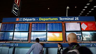 Passengers look at departure boards at Charles de Gaulle airport in Paris. Reuters
